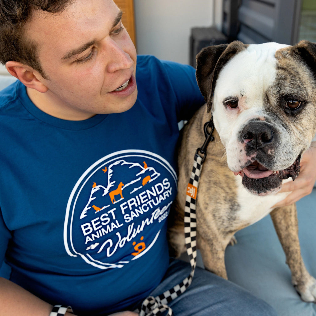 Person wearing BFAS Volunteer shirt with dog