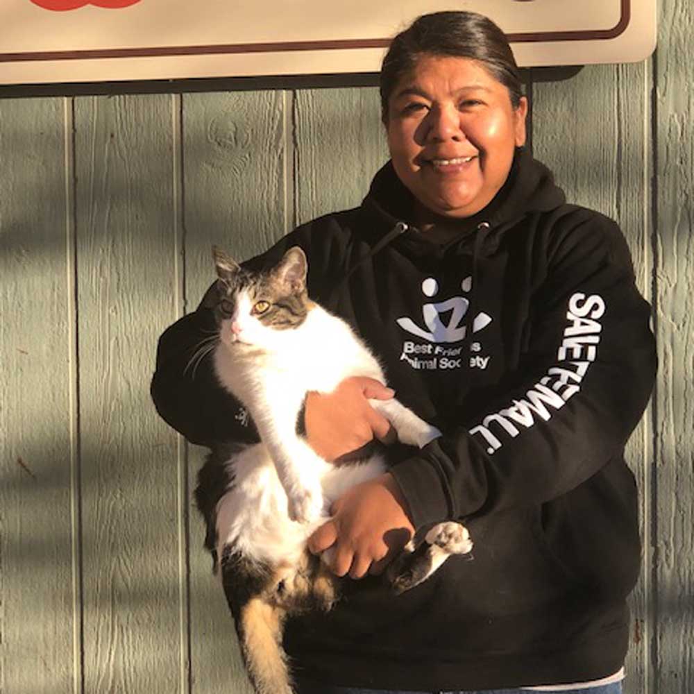Person in BFAS sweatshirt holding a cat