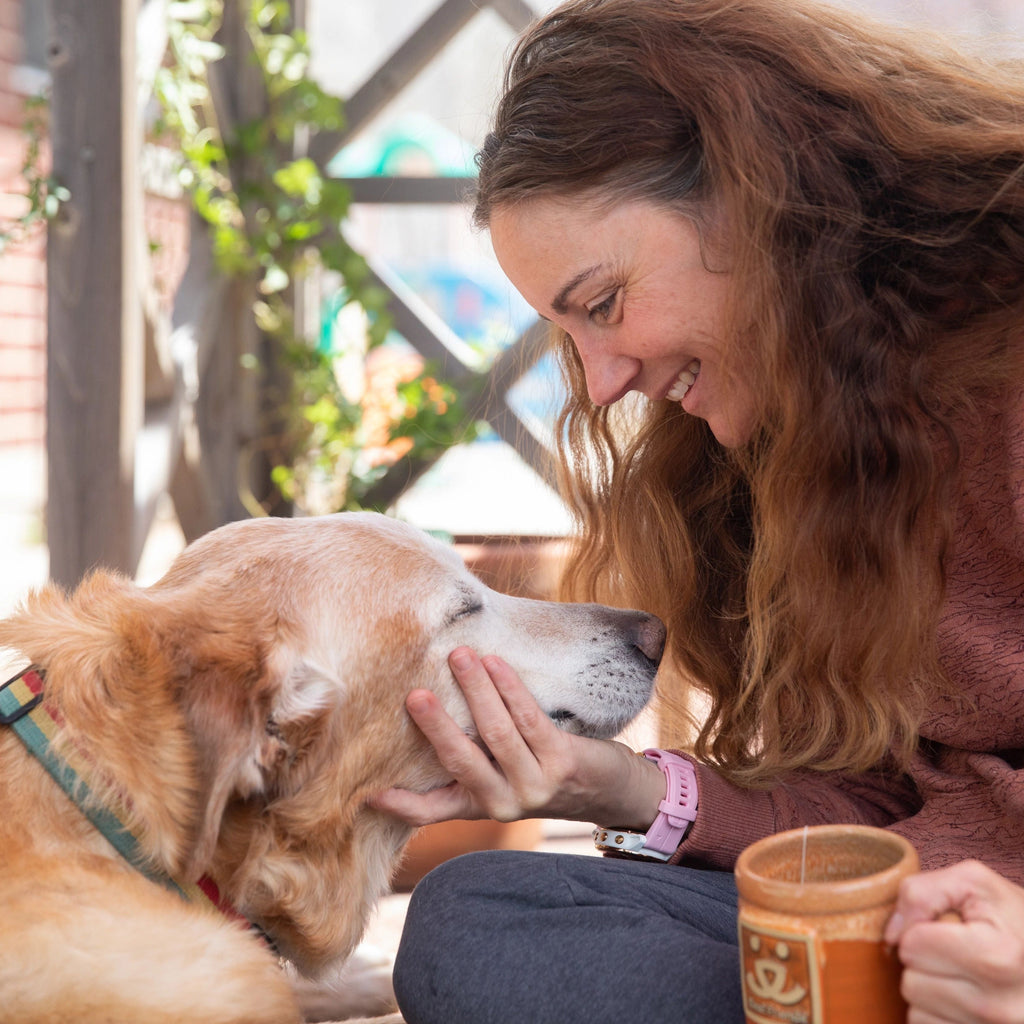 Woman with a dog and a Best Friends Animal Society mug
